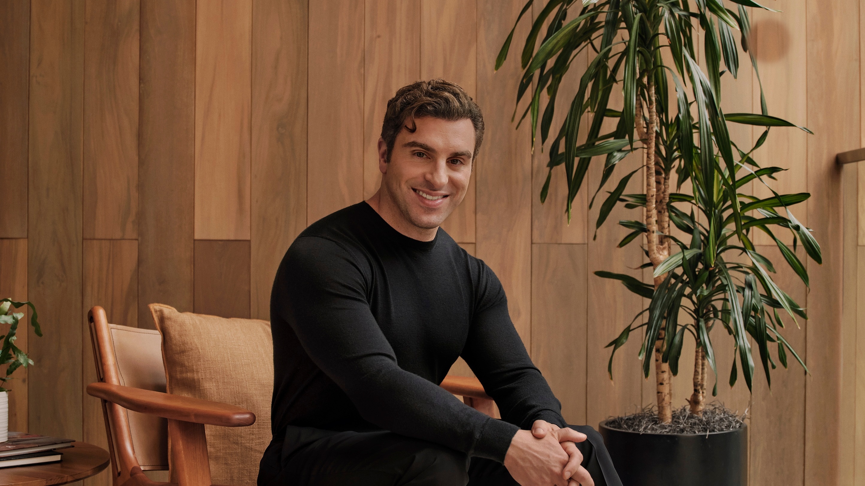 Brian Chesky seated in an Airbnb-provided portrait.