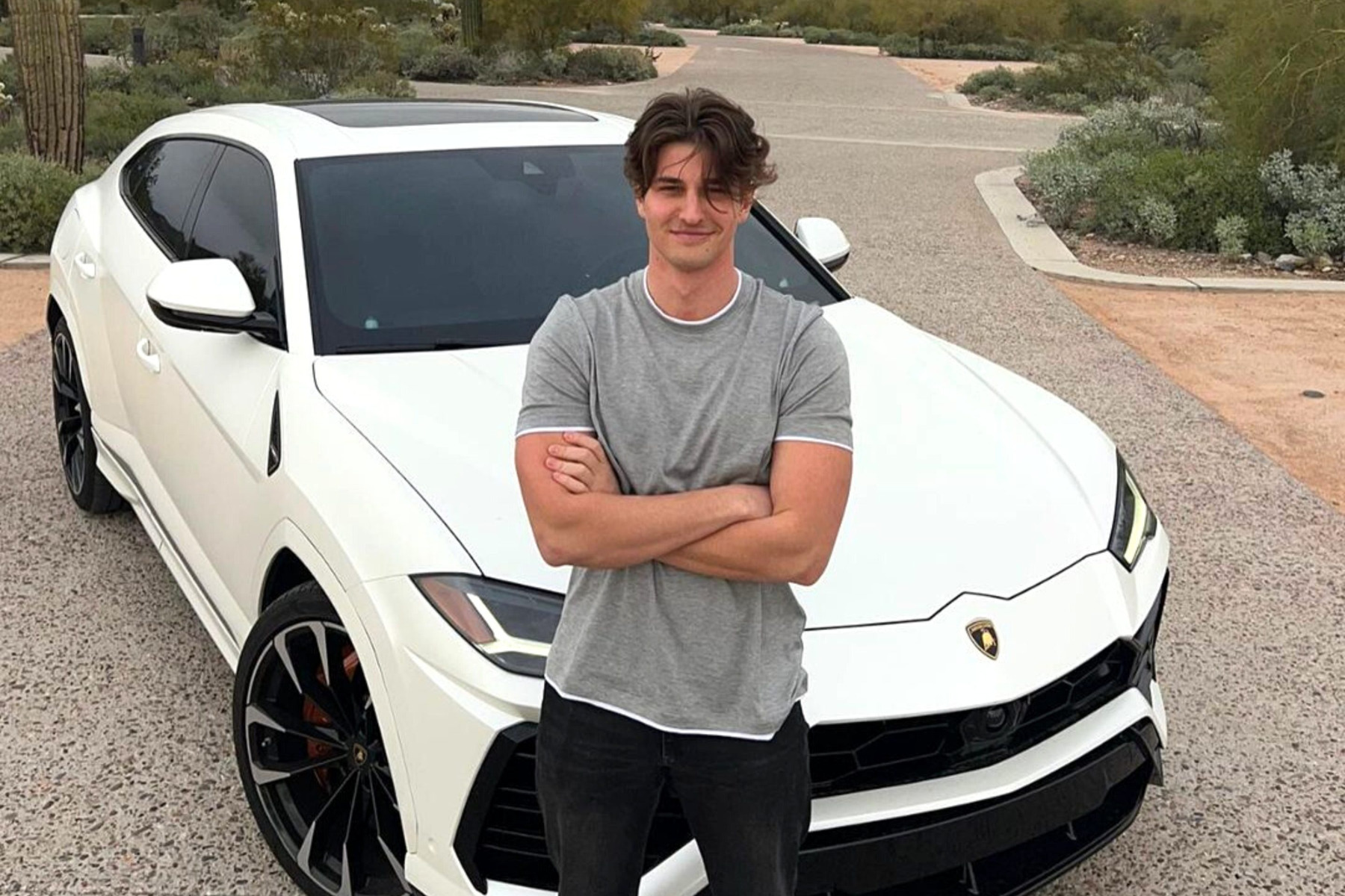 Sebastian Ghiorghiu beside a white Lamborghini.
